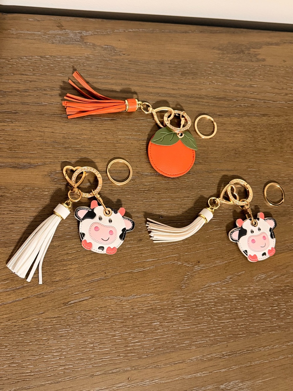 Cute Cow & Orange Tassel Bag Charm and AirTag Holder Set